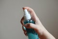 HandÃ¢â¬â¹ holdingÃ¢â¬â¹ theÃ¢â¬â¹ liquidÃ¢â¬â¹ alcoholÃ¢â¬â¹ sprayÃ¢â¬â¹ tube for cleaning and disinfecting the hands.